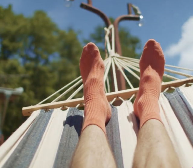 first person point of view of feet on a hammock